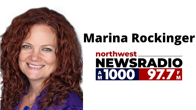 A white woman with red hair smiling at the camera. "Marina Rockinger" Northwest Newsradio logo